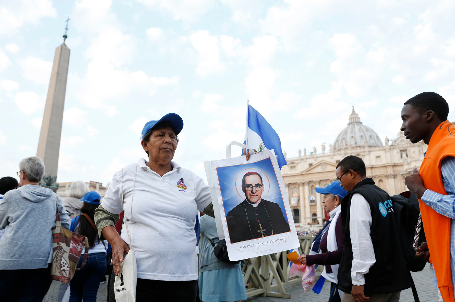 Milandro DeJesus holds a picture of St. Oscar Romero before Pope Francis’ celebration of the canonization Mass for seven new saints in St. Peter’s Square at the Vatican Oct. 14. Among the new saints are St. Paul VI and St. Oscar Romero.